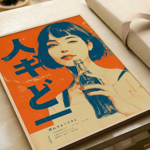 Vintage-style poster print featuring a woman with dark bob haircut holding a Coca-Cola bottle, rendered in retro Japanese advertising style with orange and blue color scheme. The illustration uses halftone dot patterns and bold typography. Japanese text appears on the left side and bottom. The print is displayed in an open book or portfolio with cream-colored pages against a white surface.