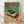 May include: Framed vintage-style Japanese poster featuring a retro turntable with red vinyl record on green and cream background. Red Japanese text at top, detailed product information below. Light wood frame displayed on wooden floor against white wall with soft shadows.