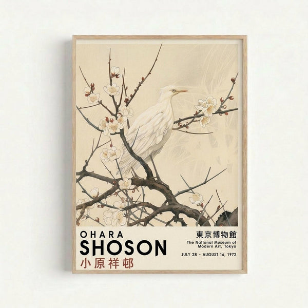 A framed vintage exhibition poster featuring a white bird perched on flowering tree branches in traditional Japanese art style. The artwork shows delicate white blossoms and dark branches against a cream background. Black text at bottom displays "OHARA SHOSON" with Japanese characters, museum information for The National Museum Modern Art Tokyo, and exhibition dates July 28 - August 16, 1972. The poster is displayed in a light wood frame against a white wall.