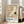 May include: A framed vintage exhibition poster featuring a white crane with outstretched wings and black wing tips against a muted beige background. The poster shows text for Ohara Shoson and The National Museum of Modern Art, Tokyo with dates July 28 - August 16, 1972. The light wood frame leans against a white wall next to a beige upholstered sofa in a bright room with large windows and wooden floors.