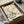 May include: Vintage Japanese art poster featuring white heron perched on flowering cherry blossom branch against cream background, displayed in black frame inside cardboard shipping box with tissue paper wrapping. Museum exhibition poster with Japanese and English text at bottom showing dates July 28 - August 16, 1972.