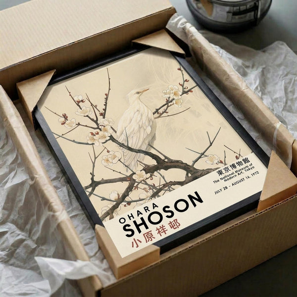 May include: Vintage Japanese art poster featuring white heron perched on flowering cherry blossom branch against cream background, displayed in black frame inside cardboard shipping box with tissue paper wrapping. Museum exhibition poster with Japanese and English text at bottom showing dates July 28 - August 16, 1972.