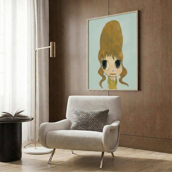 May include: Framed poster artwork featuring anime-style character with oversized blonde beehive hairstyle and large eyes on light blue background, displayed above beige upholstered armchair with geometric patterned pillow in modern living room with wood paneled walls, brass floor lamp, and side table with open book.