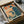 May include: Framed retro-style poster with orange and teal color scheme showing figure at vintage computer workstation, carefully packed in cardboard shipping box with protective wrapping materials and wooden frame corners visible