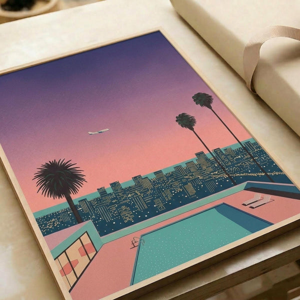 May include: Vintage-style poster print displayed on wooden surface beside white couch showing retro 1980s cityscape scene with swimming pool in foreground, palm trees, city skyline with illuminated buildings, gradient sunset sky transitioning from purple to pink, and small airplane silhouette, rendered in nostalgic Japanese-inspired aesthetic with turquoise pool water and coral pink tones