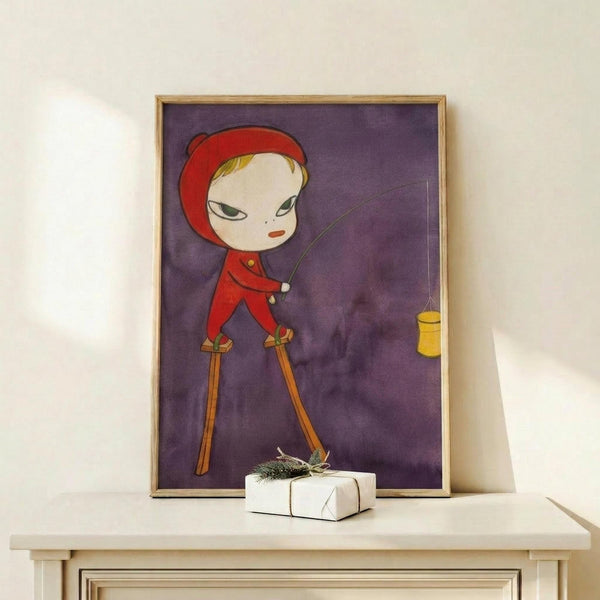 May include: Framed art print displaying a stylized character in red outfit and hat on purple watercolor background, shown in light wood frame on white shelf next to small wrapped gift with evergreen sprig