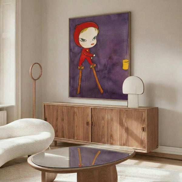 May include: Contemporary art poster featuring a stylized child character in red hooded outfit walking on stilts against purple background with small yellow lantern, displayed above wooden sideboard in modern living room with white curved chair, glass coffee table, and minimalist table lamps