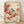 May include: Framed vintage Japanese-style artwork featuring a small bird with black cap and cream breast perched on branches heavy with bright red berries. The illustration has warm beige background with delicate botanical details. Light wood frame rests against white wall on wooden floor with soft natural lighting casting shadows.