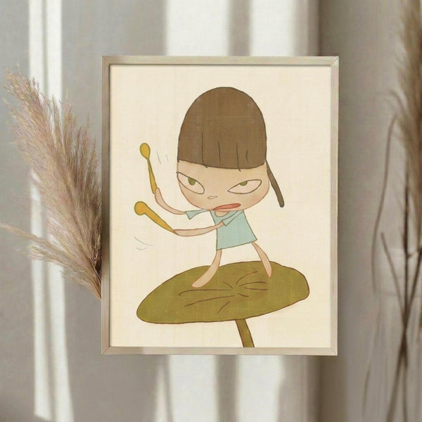 May include: Framed artwork displaying a cute cartoon character with brown bob haircut and green eyes, wearing a light blue dress, holding yellow drumsticks while standing on a large olive green mushroom. The illustration has a soft, whimsical style with muted earth tones on cream background. Simple light wood frame hangs on white wall next to dried pampas grass in natural lighting.