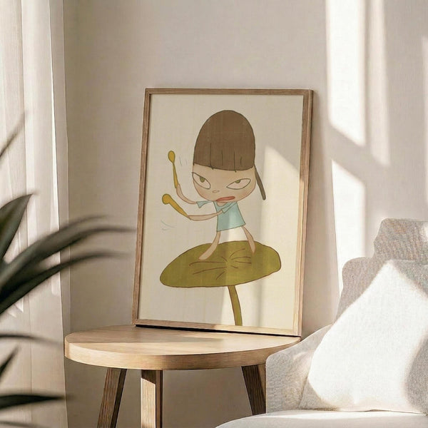 May include: Framed artwork showing a cartoon-style girl with brown bob haircut and light blue top standing on a large green leaf, displayed on a round wooden side table next to a beige upholstered chair. Sunlight streams across the neutral-toned room, casting soft shadows from a plant visible in the corner.