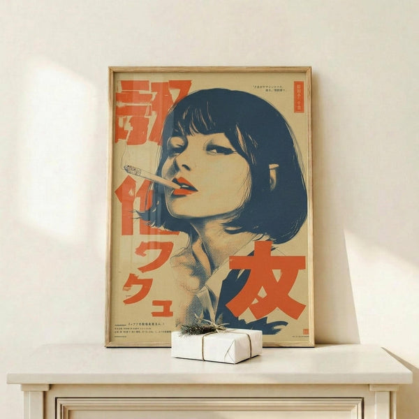 May include: Framed vintage-style poster featuring a woman with black bob haircut and cigarette, rendered in beige, red, and blue colors with Japanese text, displayed on light wood console table beside small white wrapped gift with dried grass accent against white wall