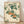 May include: Framed botanical print showing orange persimmons hanging from leafy green branches in traditional Japanese woodblock style, displayed in light wooden frame against white textured wall on wooden floor with soft natural lighting and shadows