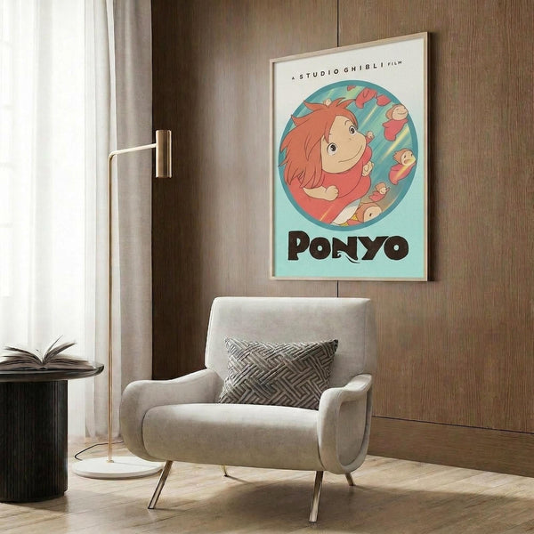 May include: Studio Ghibli Ponyo poster mounted on wood-paneled wall above beige upholstered armchair with geometric pillow. Poster features red-haired Ponyo character in circular blue frame with "PONYO" text below. Modern living room setting with brass floor lamp, side table with open book, and natural lighting from window with curtains.
