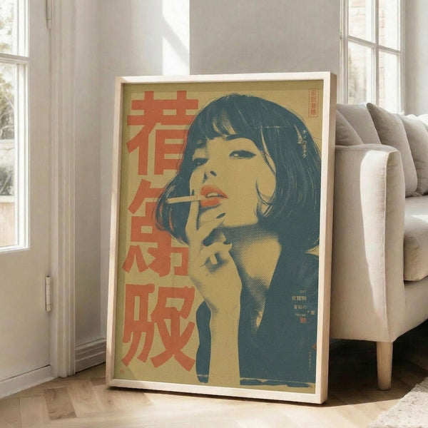 May include: Framed vintage-style poster leaning against white wall next to beige sofa in bright living room. Artwork shows woman with dark bob haircut holding cigarette, rendered in retro Japanese pop art style with yellow, teal and coral colors. Red Japanese characters visible on left side. Natural sunlight streams through windows onto hardwood floors.