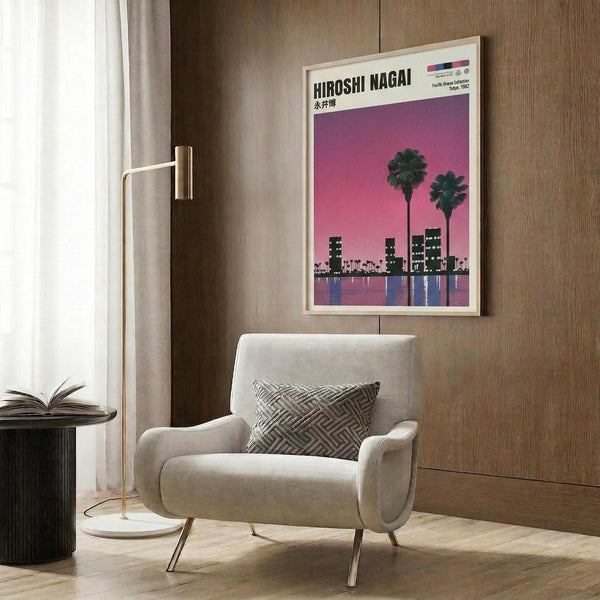 May include: Framed poster with purple-pink gradient sky, two dark palm trees, silhouetted city buildings, and water reflections, displayed above a beige upholstered armchair with geometric patterned pillow in modern living room with wood paneled walls, brass floor lamp, and side table with open book.