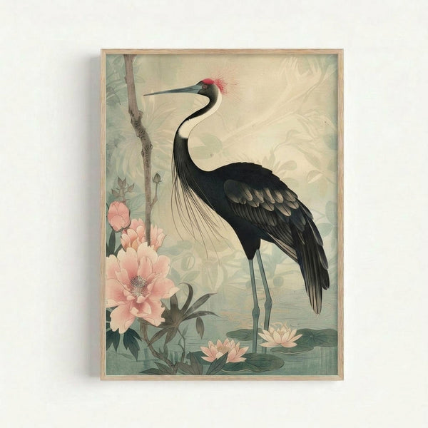 Framed vintage-style botanical art print featuring an elegant black and white crane with red head plumes standing among pink peonies and lotus flowers. The bird has a long curved neck, dark wings, and thin legs. Soft muted colors in sage green, cream, and coral pink create a serene Asian-inspired aesthetic. The artwork is displayed in a light wood frame against a white wall.
