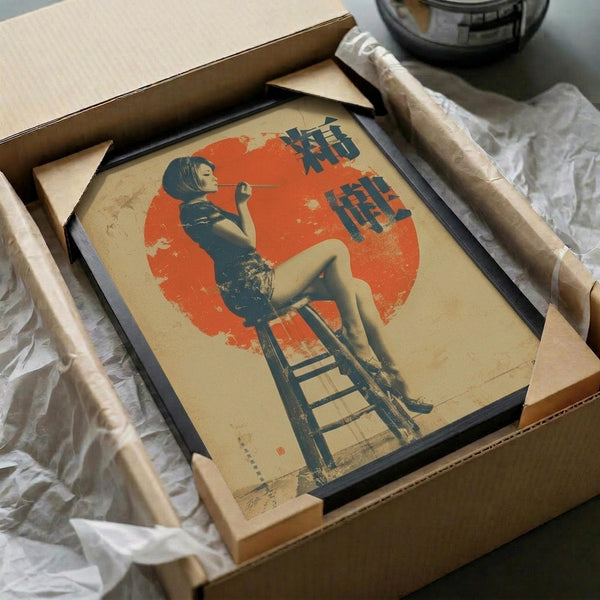 May include: Framed vintage-style poster artwork showing a woman in dark cheongsam dress sitting on wooden stool against large red circle backdrop, with blue Japanese characters in upper right corner, displayed in black frame inside cardboard shipping box with white tissue paper padding
