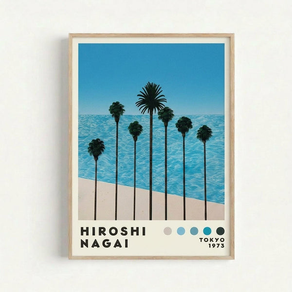 May include: Framed poster print hanging on white wall featuring stylized illustration of tall palm trees with long dark trunks against blue ocean water and beige sand beach. Clear blue sky background with geometric, clean art style. Light wood frame with white matting. Color palette dots and "TOKYO 1973" text at bottom in black lettering.