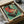 May include: Framed vintage-style poster featuring a retro turntable with red vinyl record and open lid on mint green background with Japanese text, displayed in dark frame inside cardboard shipping box with protective tissue paper packaging