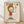 May include: Framed art print leaning against white wall on light wood floor. Artwork shows cartoon-style character with blonde bob haircut wearing red dress, making middle finger gesture. Text reads "F*ck U" in red letters at top and "YOSHITOMO NARA" with Japanese characters and date at bottom. Natural wood frame with cream matting, soft natural lighting creating diagonal shadows.