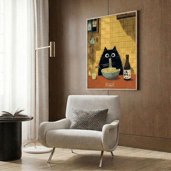 May include: Framed poster print displayed on wood paneled wall above cream upholstered armchair with geometric pillow. Artwork shows black cat with wide eyes eating noodles from bowl in Japanese-style kitchen setting with yellow tile walls, bottles, and warm lighting. Gold floor lamp and dark round table with open book visible in modern room scene.