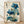May include: Framed botanical print featuring blue poppy flowers with stems, leaves, and seed pods against an aged cream background with Asian calligraphy text. The artwork shows detailed watercolor-style illustrations in shades of blue and green, displayed in a natural wood frame leaning against a white wall on light wooden flooring.