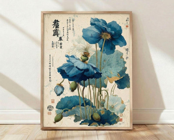 May include: Framed botanical print featuring blue poppy flowers with stems, leaves, and seed pods against an aged cream background with Asian calligraphy text. The artwork shows detailed watercolor-style illustrations in shades of blue and green, displayed in a natural wood frame leaning against a white wall on light wooden flooring.