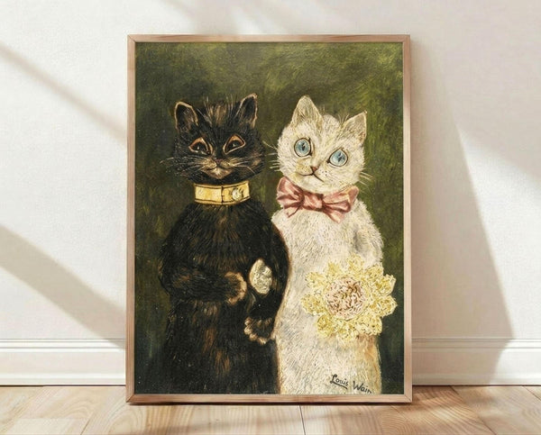 May include: Framed vintage-style illustration of two anthropomorphic cats in wedding attire against olive green background. Black cat wears golden collar, white cat with blue eyes wears pink bow tie and holds yellow bouquet. Art print displayed in light wood frame on wooden floor against white wall with natural lighting.
