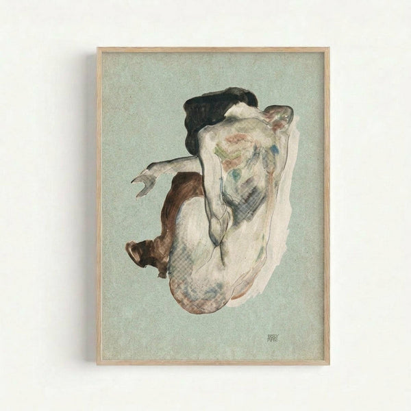 May include: Framed reproduction of an early 20th century expressionist drawing showing a crouching nude figure with dark hair against a pale green background. The artwork features loose, gestural lines in watercolor and pencil with muted earth tones. Displayed in a light wood frame on a white wall.