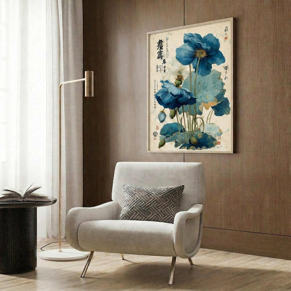 May include: Framed botanical artwork featuring blue poppies with Oriental calligraphy displayed on wood-paneled wall above beige upholstered armchair with geometric patterned pillow. Modern brass floor lamp and dark round side table with open book complete the neutral-toned interior setting with natural lighting from window.