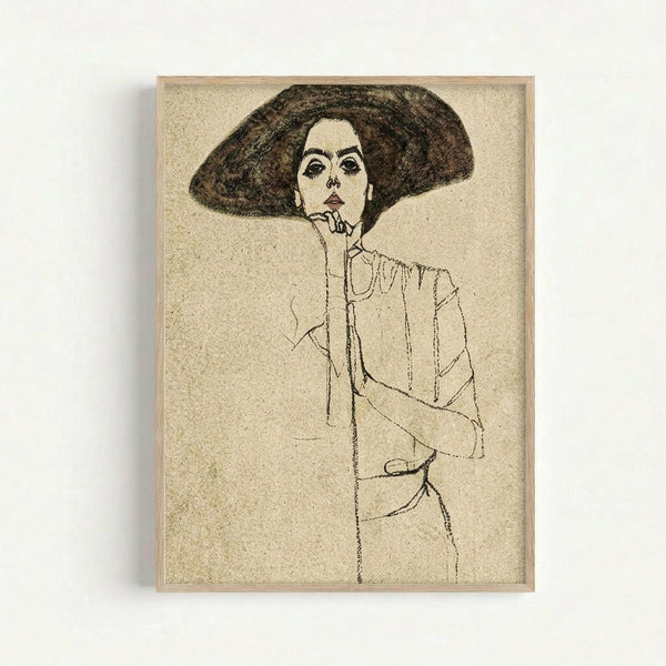 A black and white line drawing of a woman wearing a large wide-brimmed hat, rendered in an expressive early 20th century style. The sketch shows the subject with one hand raised to her chin in a contemplative pose, wearing what appears to be a loose-fitting garment. The artwork is displayed in a light wooden frame against a white wall, with visible paper texture and aging on the cream-colored background.