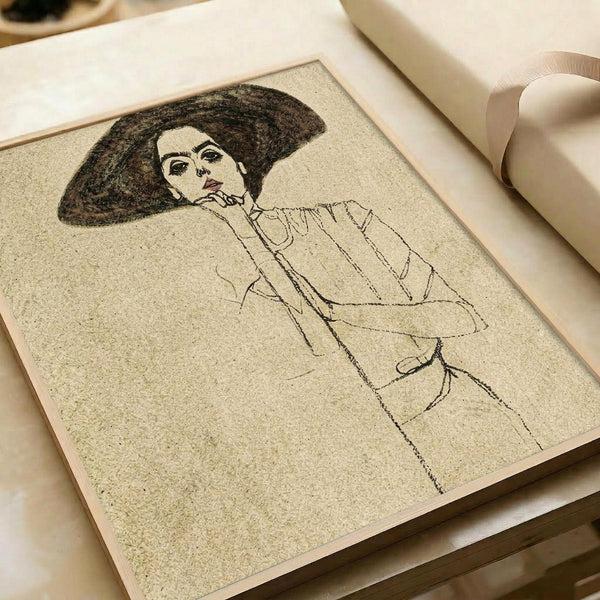 Black line drawing portrait of a woman with voluminous dark hair wearing a light-colored blouse with vertical pleats or ruffles. The sketch shows minimalist facial features and flowing fabric details on textured beige paper. The artwork is displayed in an open portfolio or art book with cream-colored pages and ribbon binding visible at the edges.