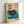 May include: Framed vintage-style poster featuring a teal turntable with black vinyl record and orange center label, displayed in light wood frame against white wall. Design includes Japanese characters in red rectangle, small text blocks, and retro aesthetic with cream background and turquoise accent elements.