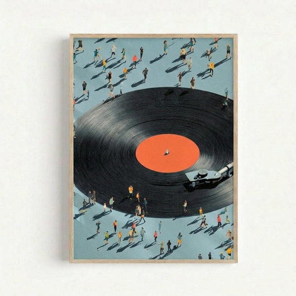 Surreal artwork showing a giant black vinyl record with orange center label dominating the composition, surrounded by dozens of tiny people casting long shadows on a light blue surface. A turntable arm extends from the right side of the record. The people appear to be walking or standing around the massive record, creating a striking sense of scale. The piece is displayed in a thin wooden frame against a white wall.