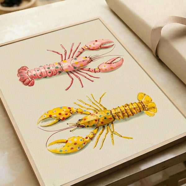 May include: Two whimsical lobster illustrations displayed in a cream-colored matted frame, resting on white furniture with a beige ribbon nearby. The top lobster is pink with colorful polka dots, while the bottom one is golden yellow with similar spotted patterns. Both creatures feature detailed anatomical elements like segmented tails, claws, and antennae rendered in a vintage scientific illustration style against an off-white background.