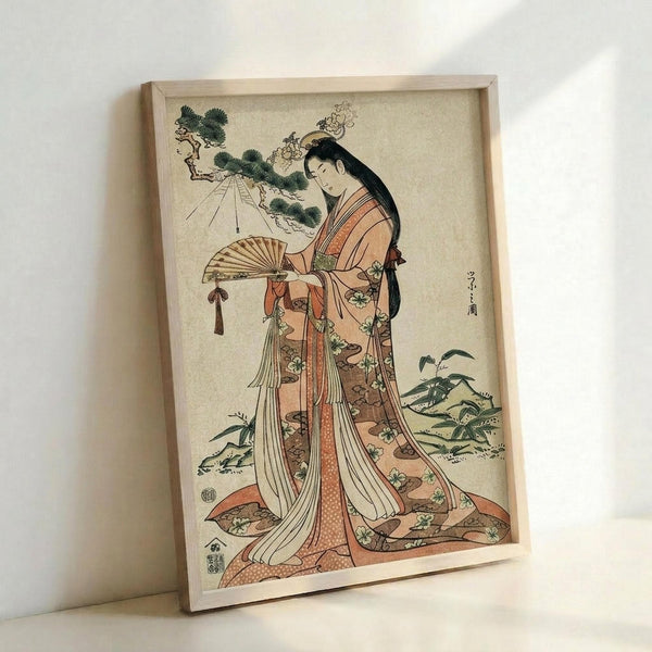 May include: Japanese woodblock print artwork displayed in light wooden frame against white wall. Shows woman in elaborate coral and cream kimono with floral patterns holding decorative fan, long black hair adorned with ornaments. Traditional ukiyo-e style with soft colors and delicate linework, surrounded by stylized pine trees and foliage on cream background.