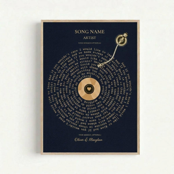 Framed navy blue poster with gold text featuring song name and artist at top, spiral of song lyrics arranged around wooden vinyl record center with small heart, tonearm extending from top right corner, and personalized message with two names at bottom, displayed against white wall