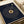 May include: Navy blue square poster with gold text arranged in a spiral pattern around a central vinyl record design. Song lyrics curve in concentric circles with "SONG NAME" and "ARTIST" at top, and "Oliver & Meaghan" signature at bottom. Displayed in white gift box with cream ribbon, showing elegant typography on dark background.