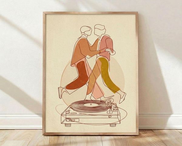 May include: Framed poster print leaning against white wall on wooden floor. Artwork shows minimalist line art of dancing couple in warm earth tones - orange, coral, and olive green clothing - positioned above outlined turntable. Cream background with soft geometric triangular shapes. Natural wood frame, soft natural lighting creates diagonal shadows across scene.