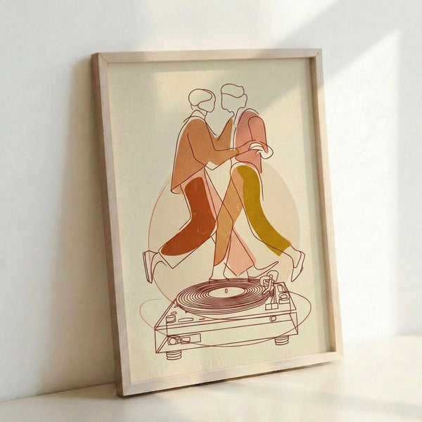 May include: Framed minimalist line art print leaning against white wall showing two abstract figures dancing together in warm earth tones of orange, pink, and olive green, with a vintage turntable drawn in simple brown lines below them. The artwork is displayed in a light wood frame on cream-colored paper.