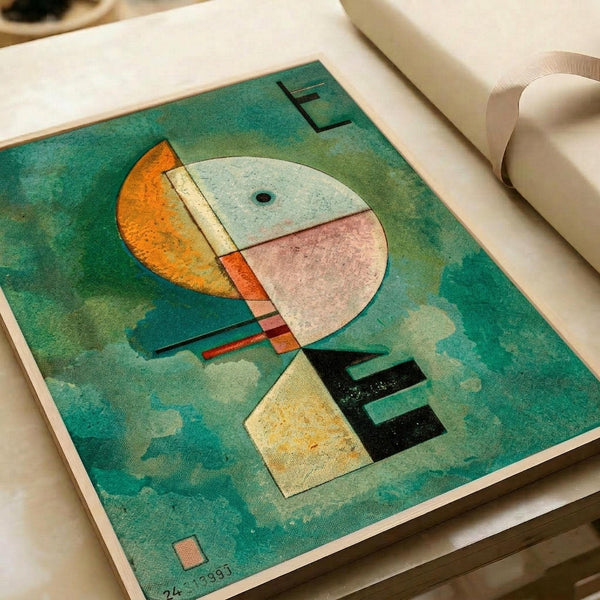 Abstract geometric artwork with circular and rectangular shapes in orange, white, pink, yellow, and black against a turquoise-green textured background. The composition features intersecting lines and forms in Kandinsky's distinctive style, dated 1924. The print is displayed in an open book or portfolio with white pages and neutral ribbon binding.