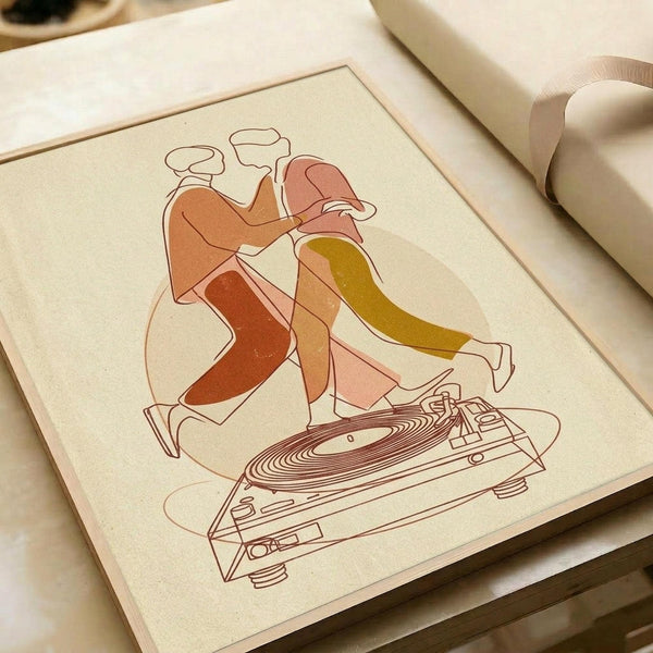 May include: Minimalist line art print on cream paper showing two dancing figures in warm coral, rust, and olive tones positioned above a detailed turntable illustration. The stylized artwork features flowing, abstract human forms with chef's hats, rendered in modern geometric style. Print appears matted in light wooden frame, positioned on white surface next to rolled white paper.