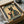 May include: Vintage-style poster featuring a black cat with yellow eyes wearing a traditional Japanese kimono with floral patterns, holding a red teacup. The cat is illustrated in retro advertising style with "MORE ESPRESSO" at top and "LESS DEPRESSO" at bottom. The framed print sits in a cardboard shipping box with protective tissue paper, showing warm beige and green color tones with Asian-inspired design elements.