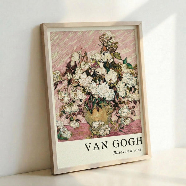 May include: Framed art print showing Van Gogh's white roses painting in light wood frame, leaning against white wall. The artwork features abundant white roses with green leaves in a vase against pink background with characteristic Van Gogh brushstrokes. Text below reads "VAN GOGH 'Roses in a vase'". Soft natural lighting creates gentle shadows on the wall.