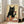 May include: Large framed poster print leaning against white wall in bright living room with beige sofa. Artwork shows black cat with green eyes holding wine glass, surrounded by various cheeses on wooden surface. Vintage-style illustration with cream background and warm earth tones in white frame.
