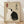 May include: Framed poster print leaning against white wall on wooden floor. Artwork features two cats in yin-yang formation on textured beige background - one white cat and one black cat sitting back-to-back with curved tails creating circular balance. Japanese characters appear on right side with red rectangular seal stamp on left. Light wooden frame surrounds the minimalist Asian-inspired design.