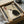 May include: Framed artwork featuring two cats in yin yang formation - one white, one black - on beige textured background with Japanese characters and red stamp seal. Black frame sits in open cardboard shipping box with tissue paper padding and wooden rolling tubes nearby on white surface.