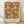 May include: Framed poster with William Morris floral pattern in warm brown and cream colors, featuring detailed botanical design with large blooming flowers and curving leaves. Light wooden frame rests against white textured wall on natural wood flooring with soft natural lighting creating gentle shadows.