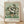 May include: Framed art print of Van Gogh's white roses in a vase painting displayed on light wooden floors against white textured walls. The artwork features cream-colored roses with green foliage in an earthenware vase against a pale green background, shown in a thin natural wood frame with white matting.