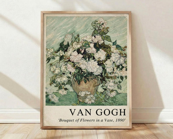 May include: Framed art print of Van Gogh's white roses in a vase painting displayed on light wooden floors against white textured walls. The artwork features cream-colored roses with green foliage in an earthenware vase against a pale green background, shown in a thin natural wood frame with white matting.